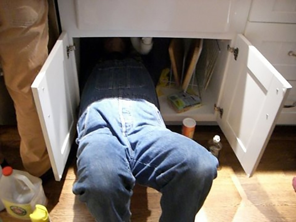 plumber under the sink